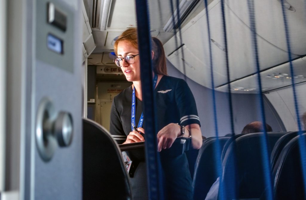 United Airlines flight attendants take a meal order onboard a plane