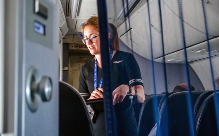 United Airlines flight attendants take a meal order onboard a plane