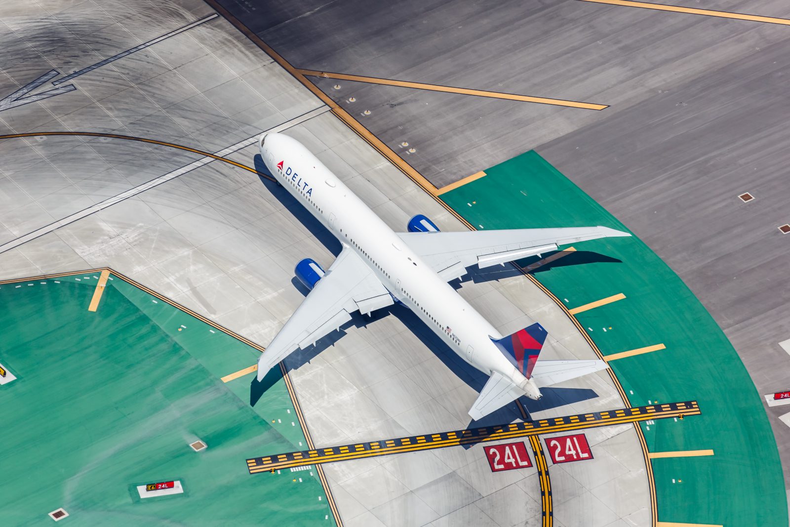 A Delta Air Lines aircraft, seen from above, taxis on the tarmac at Los Angeles International Airport