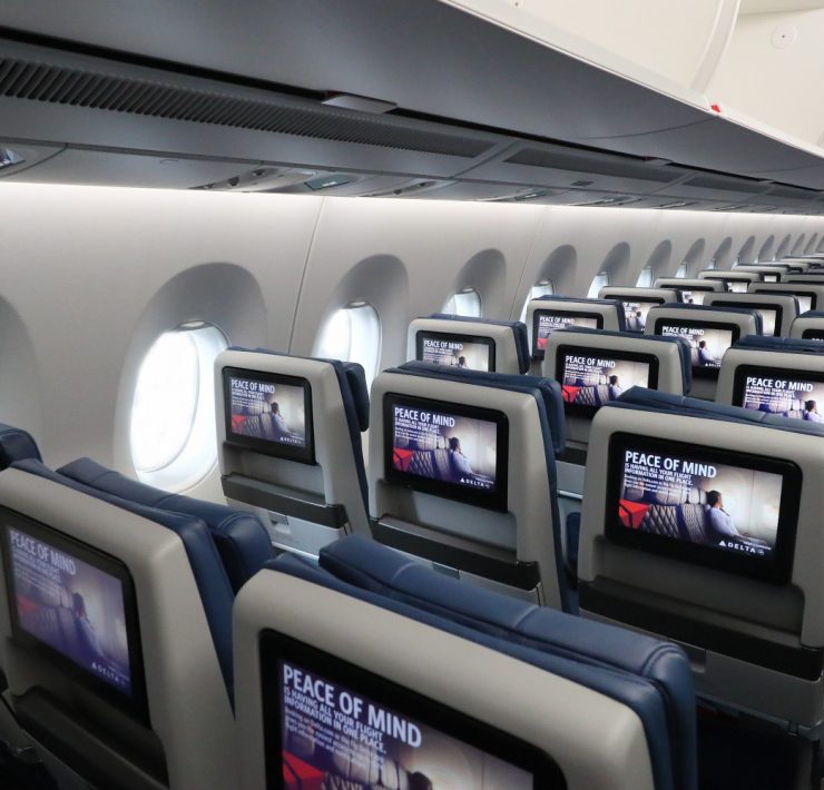 a row of seats with monitors on the side