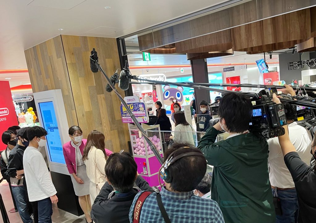 a group of people in a room with a camera