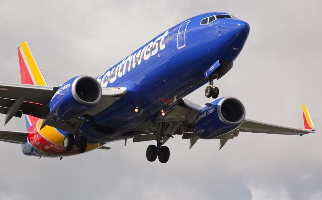 a blue airplane in the sky