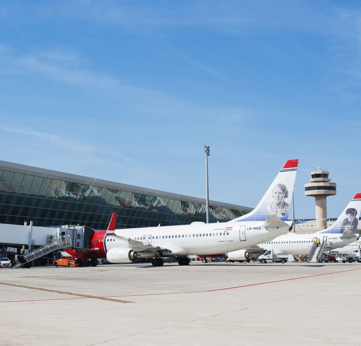 a group of airplanes parked in a terminal