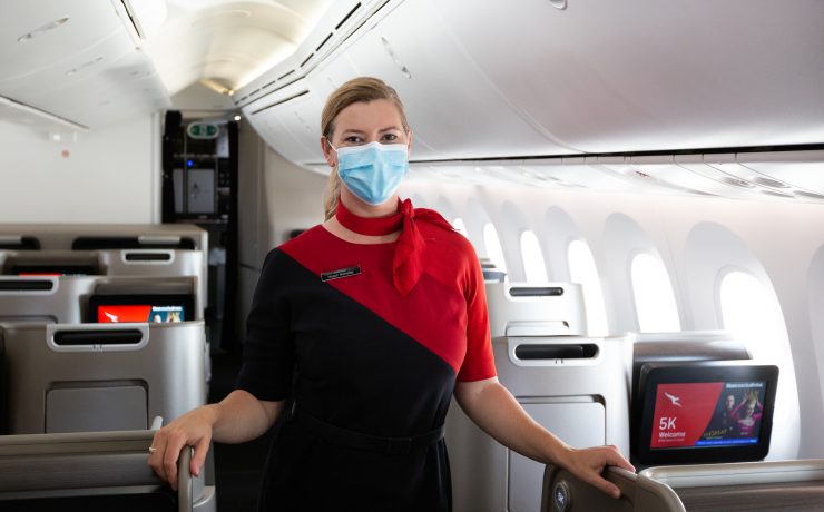 a woman wearing a face mask on an airplane