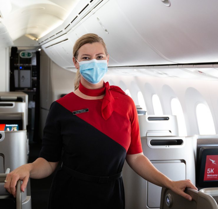 a woman wearing a face mask on an airplane