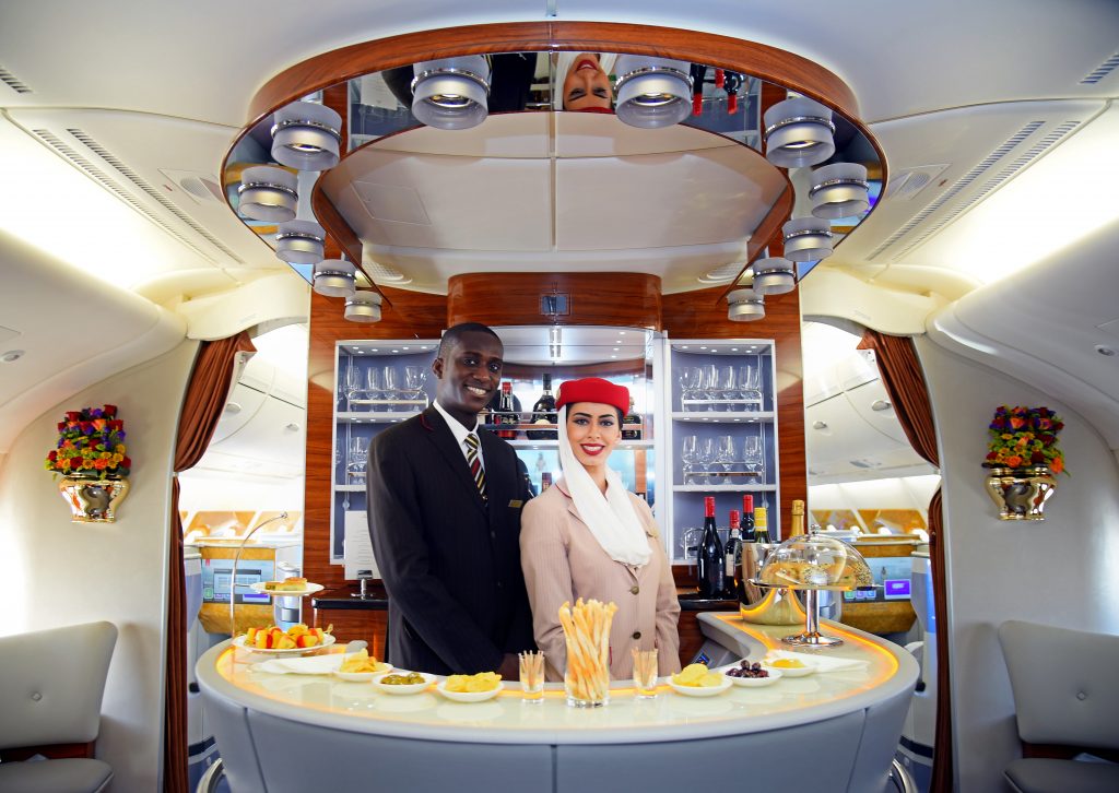 a man and woman standing behind a counter in an airplane
