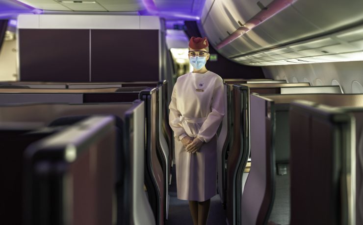 a person wearing a mask and standing in an airplane