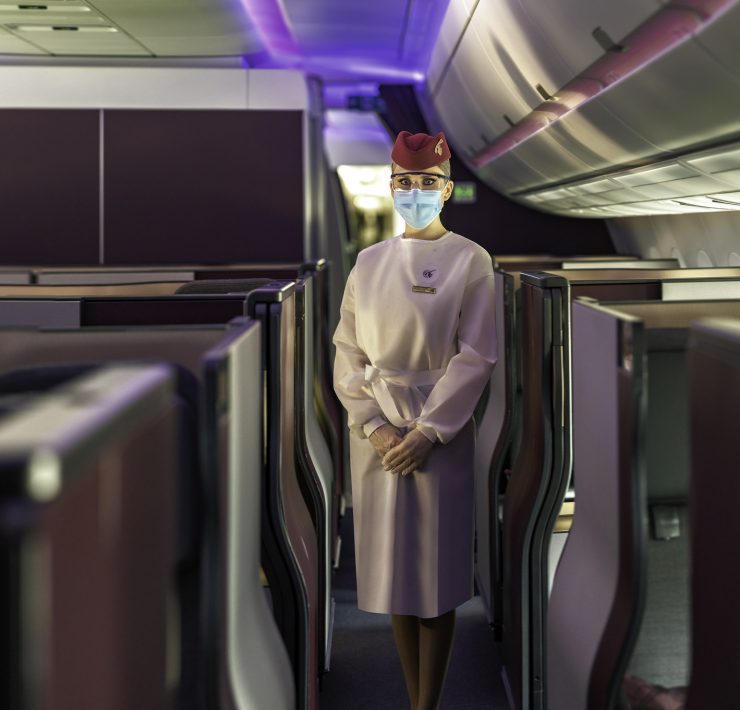 a person wearing a mask and standing in an airplane