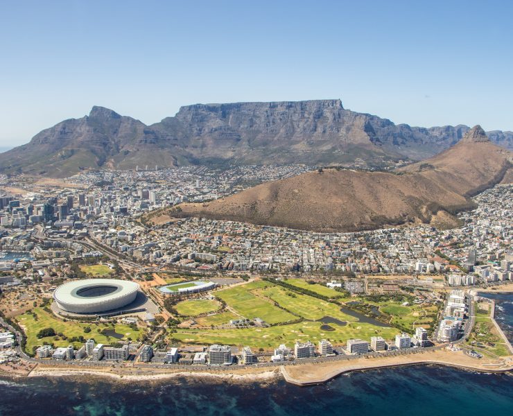 Table Mountain with a large stadium and a body of water