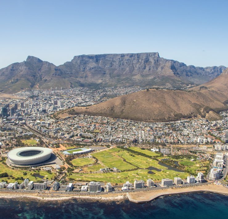 Table Mountain with a large stadium and a body of water