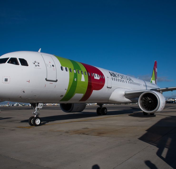 a white airplane with green and red stripes on it