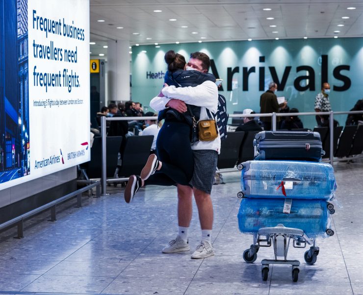 a man and woman hugging in an airport