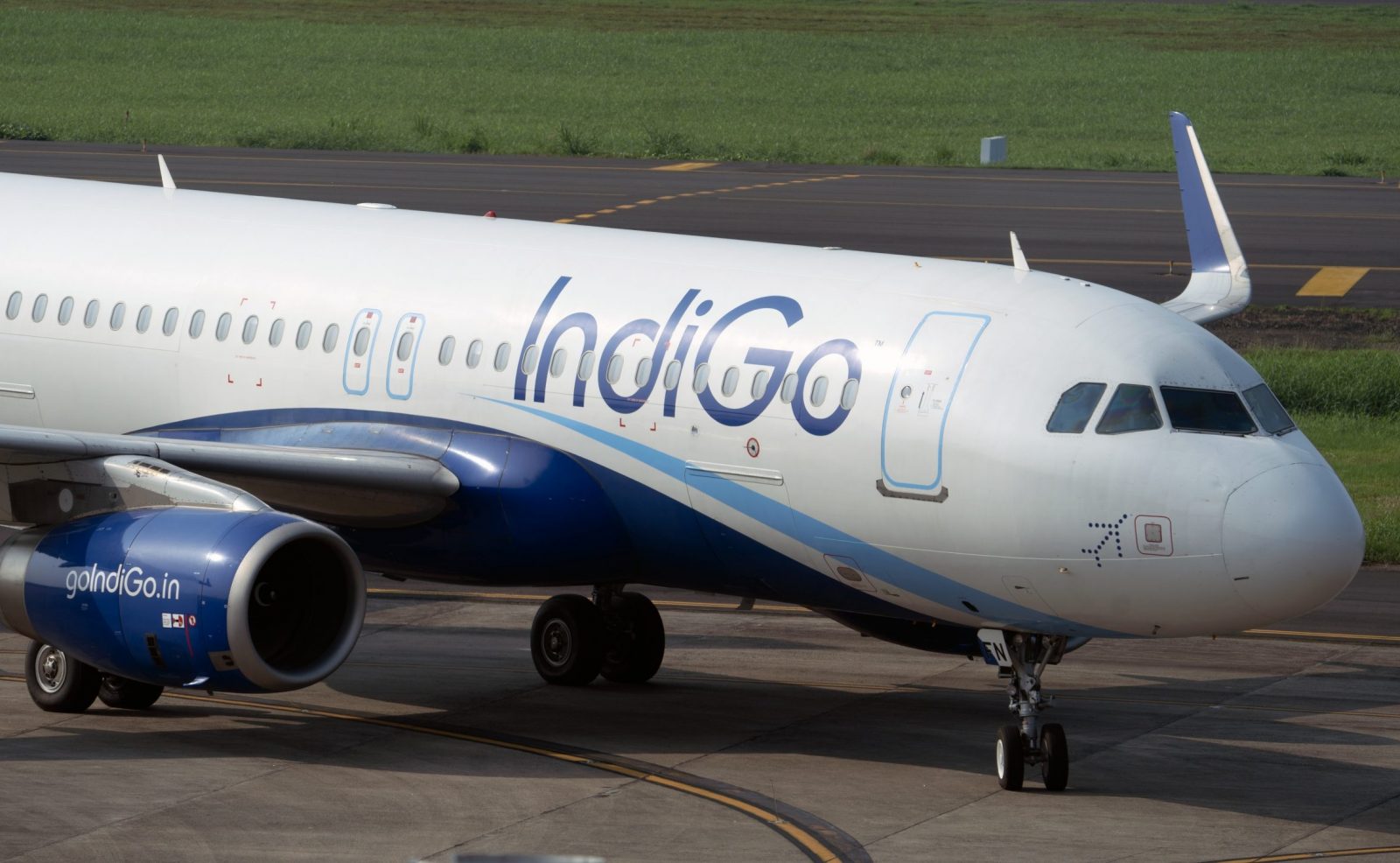 a white and blue airplane on a runway