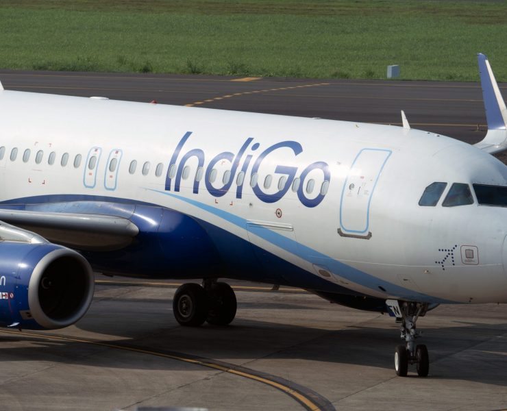 a white and blue airplane on a runway