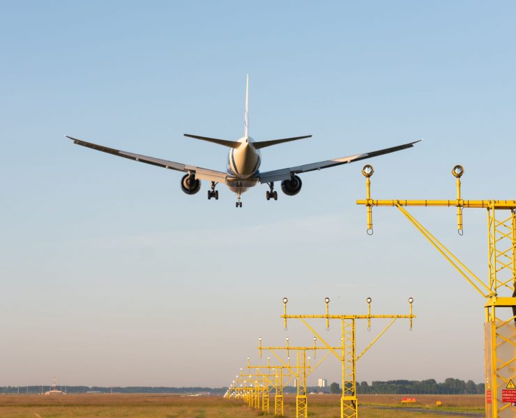 an airplane flying over runway