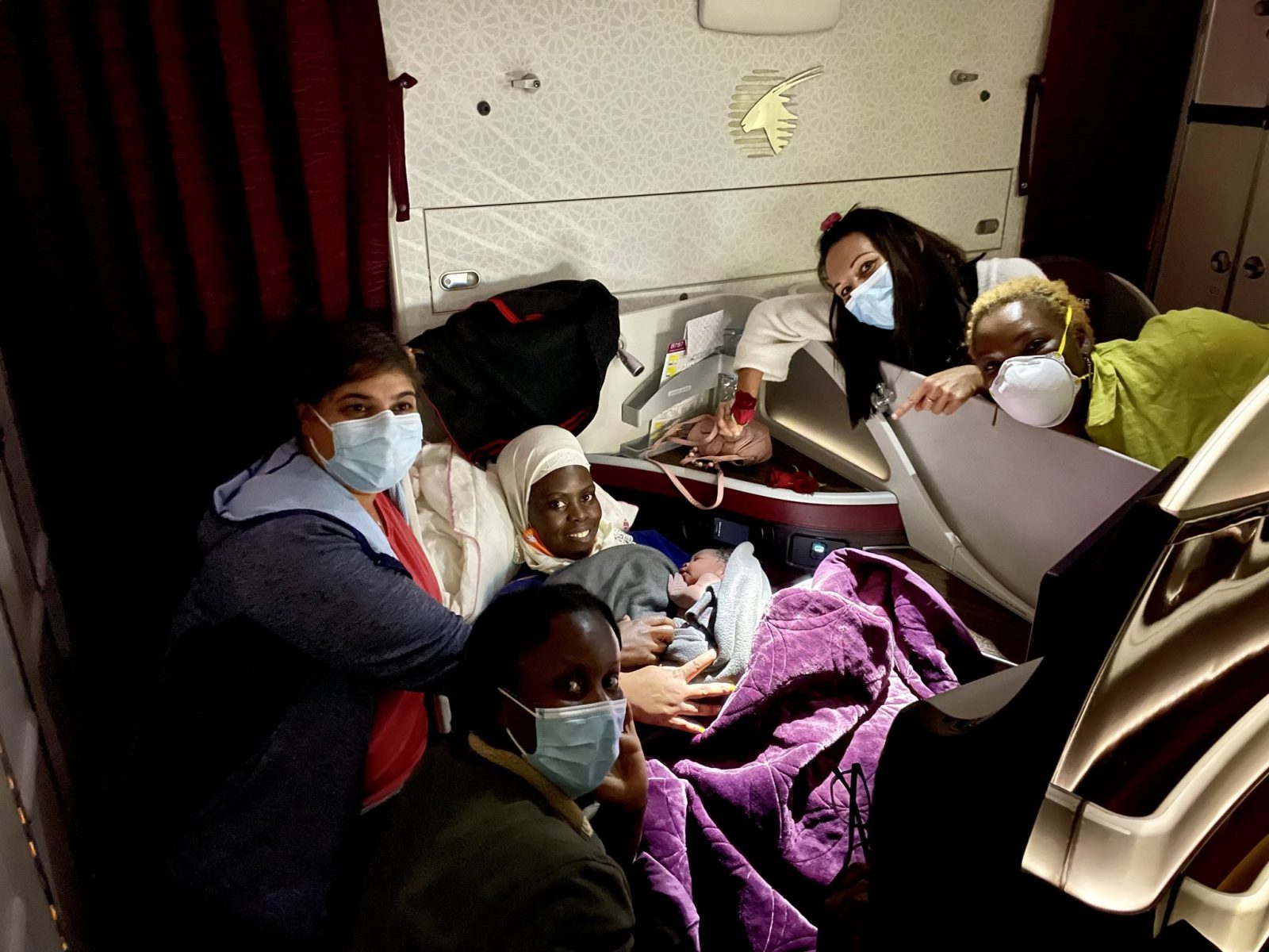 a group of people in a plane with masks
