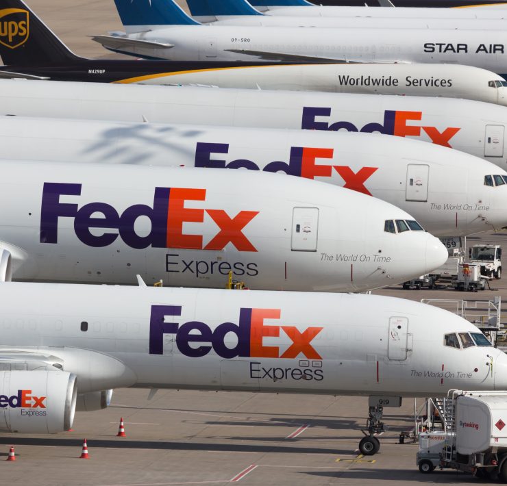 a group of airplanes parked on a tarmac