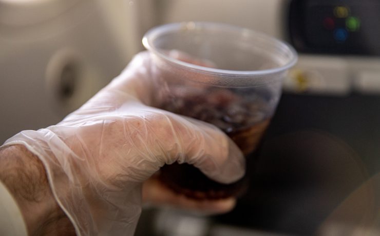a hand holding a plastic cup