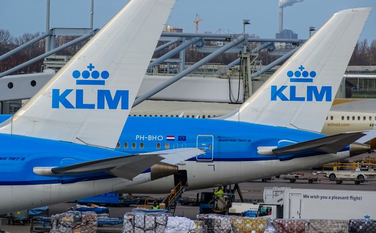 a group of airplanes parked at an airport