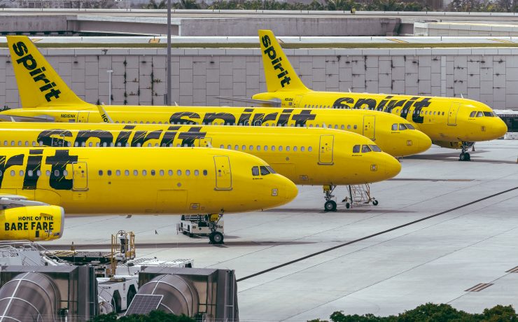a group of yellow airplanes parked at an airport