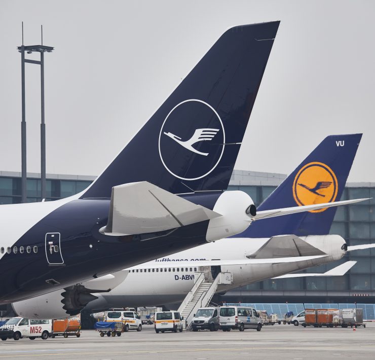 a group of airplanes parked at an airport