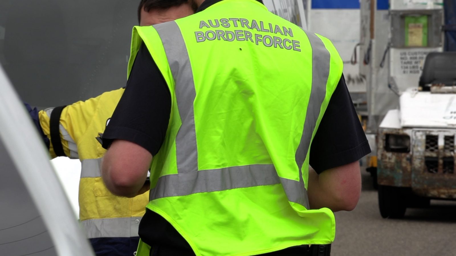 a man in a yellow vest