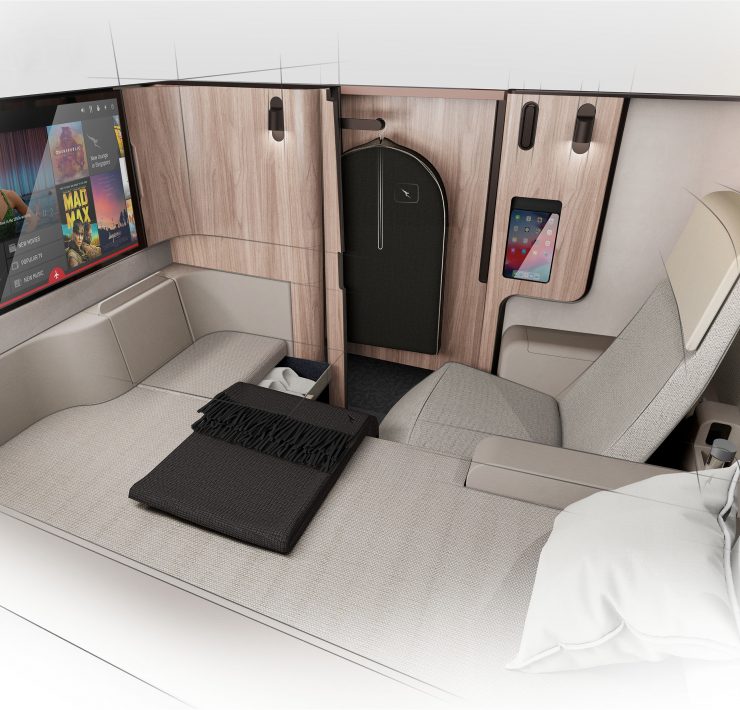 a bed with a screen on the wall