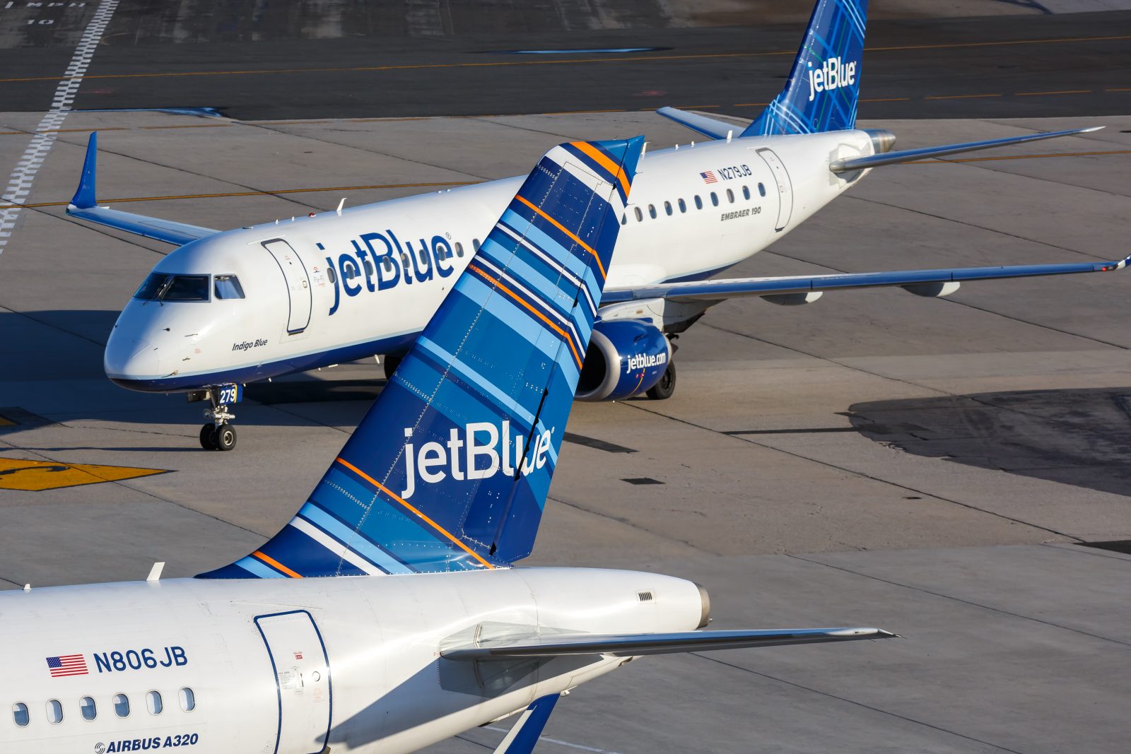 a group of airplanes on a runway