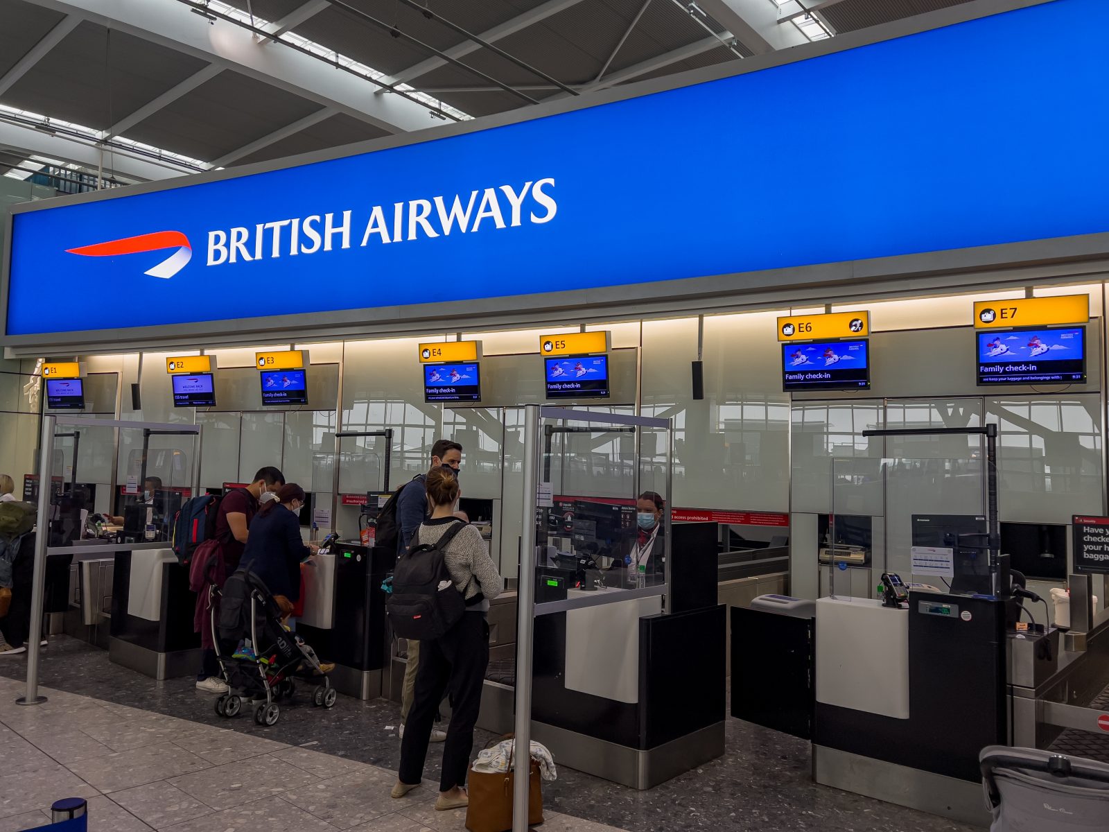 people standing in front of a check in counter