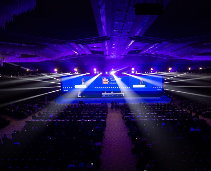 a large room with a large screen with bright lights