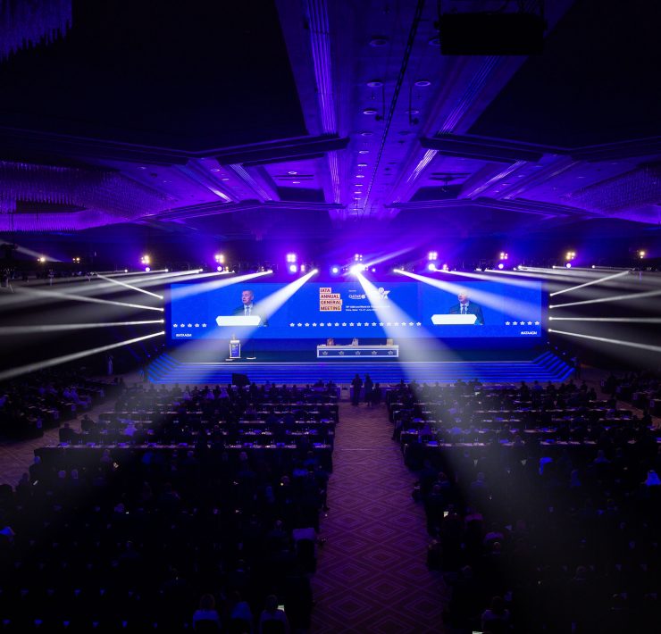 a large room with a large screen with bright lights