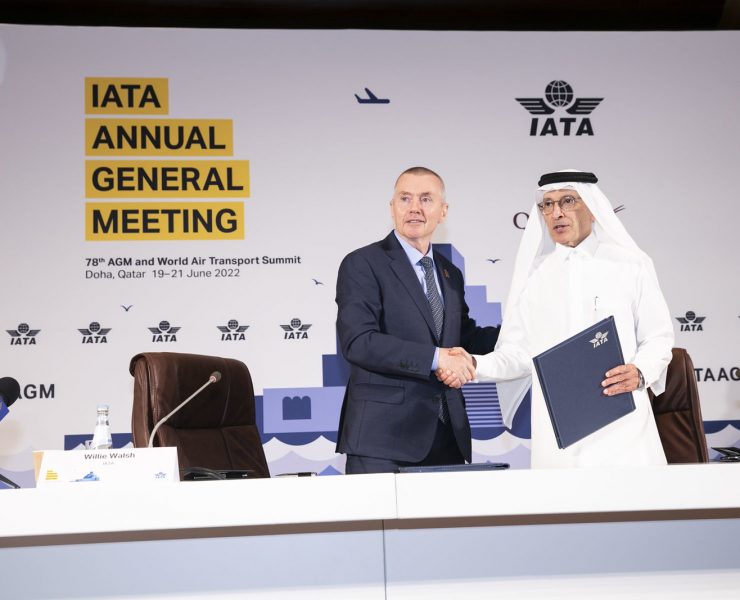 a man shaking hands with another man in a suit