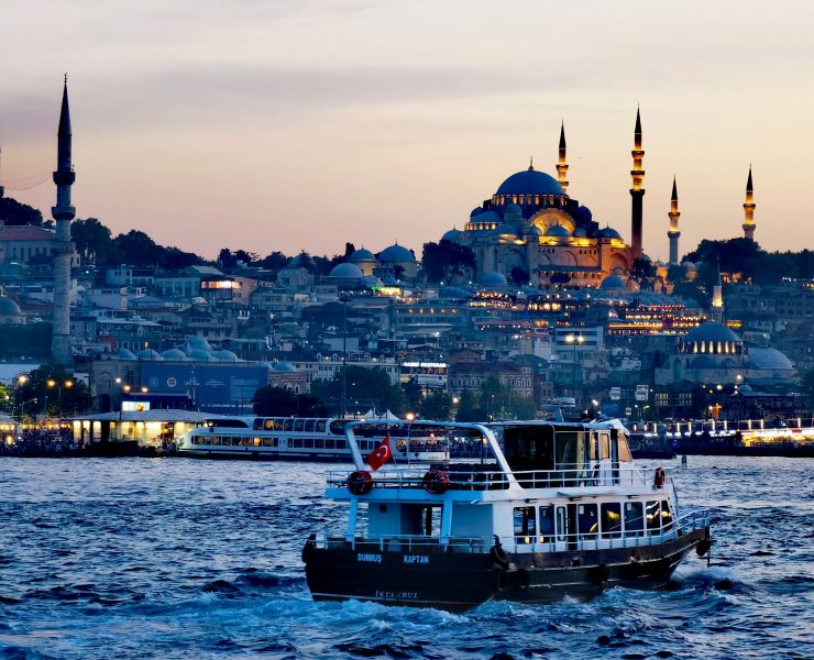 a boat on the water with a city in the background