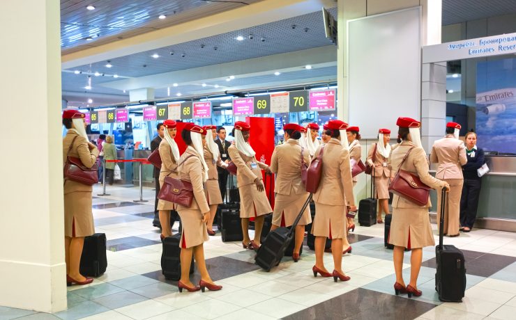 a group of people in uniforms with luggage