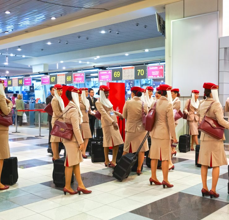 a group of people in uniforms with luggage
