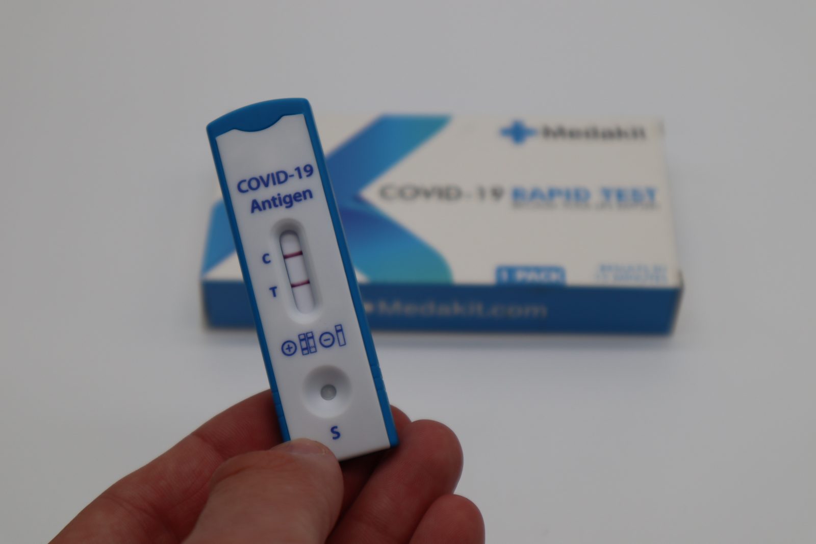 a hand holding a rapid test