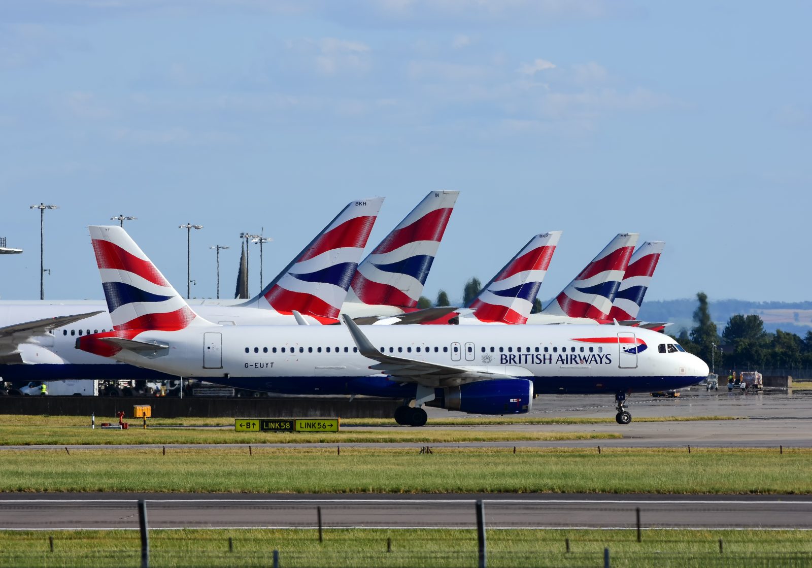 a group of airplanes on a runway