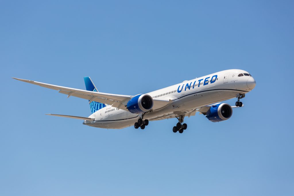 a white airplane with blue text on it