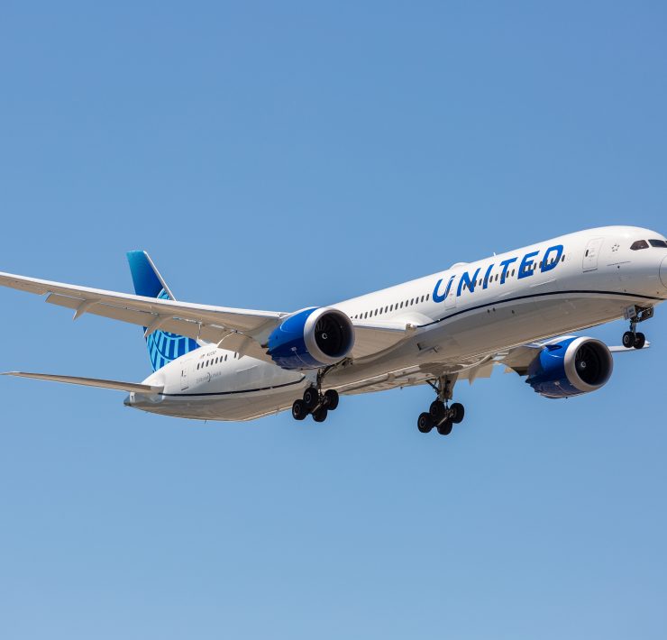 a white airplane with blue text on it