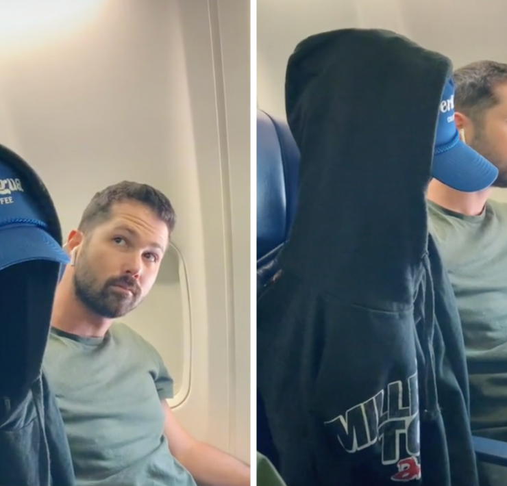 a man sitting in a chair with a hood on his head