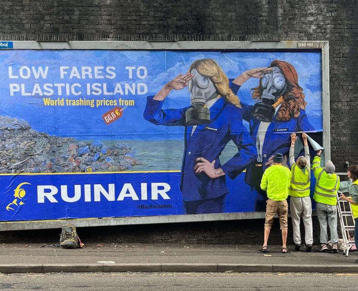a group of people standing by a large sign