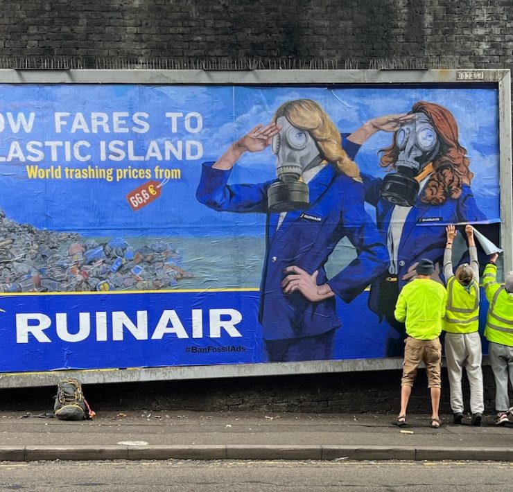 a group of people standing by a large sign