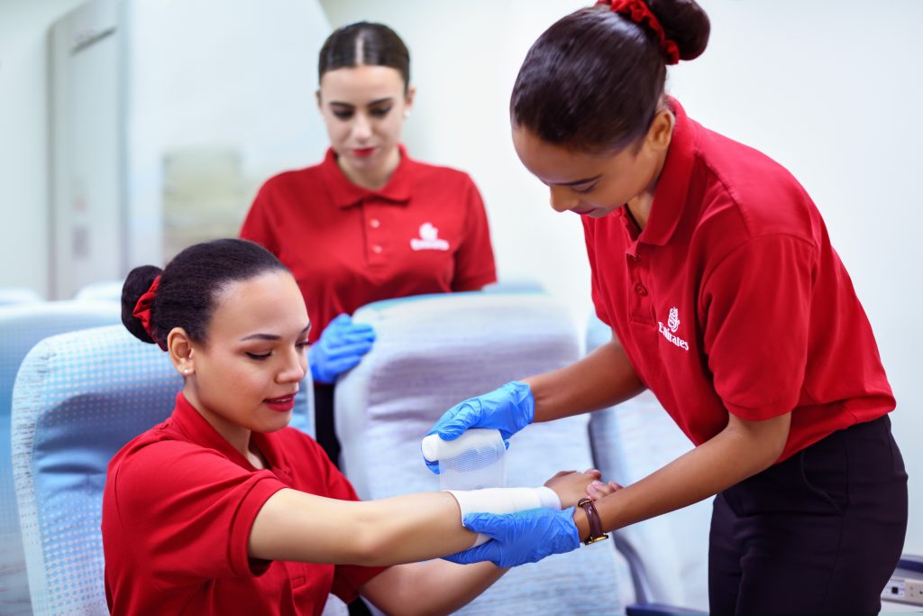 a group of women wearing red shirts and gloves