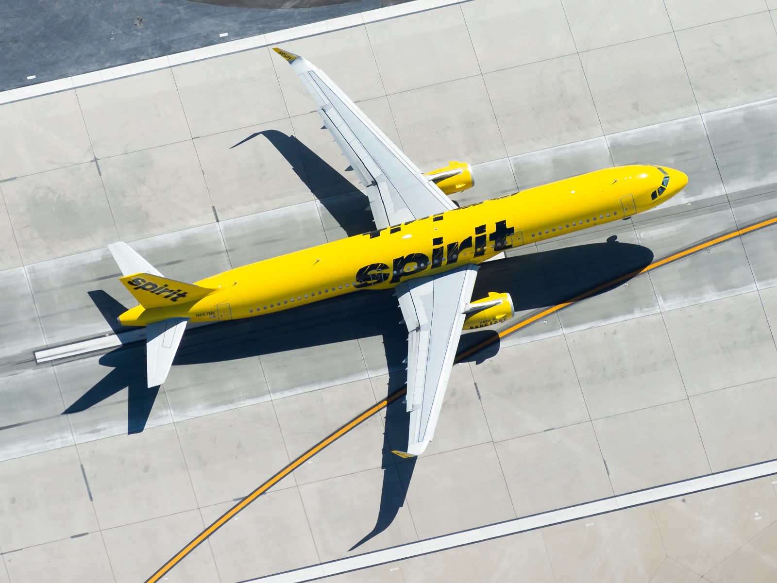 a yellow airplane on a runway