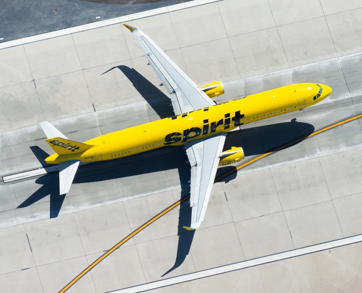 a yellow airplane on a runway