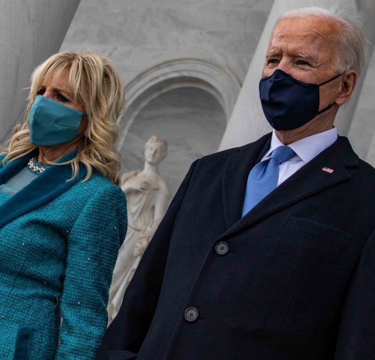 a man and woman wearing face masks