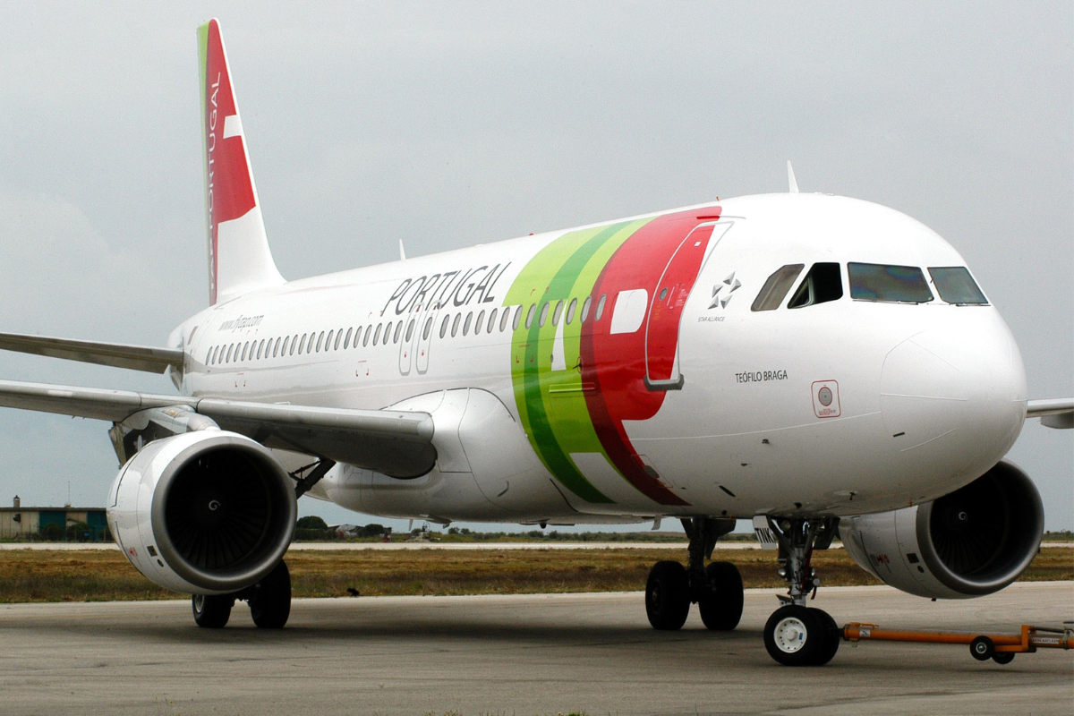 a white airplane with red and green stripes on it
