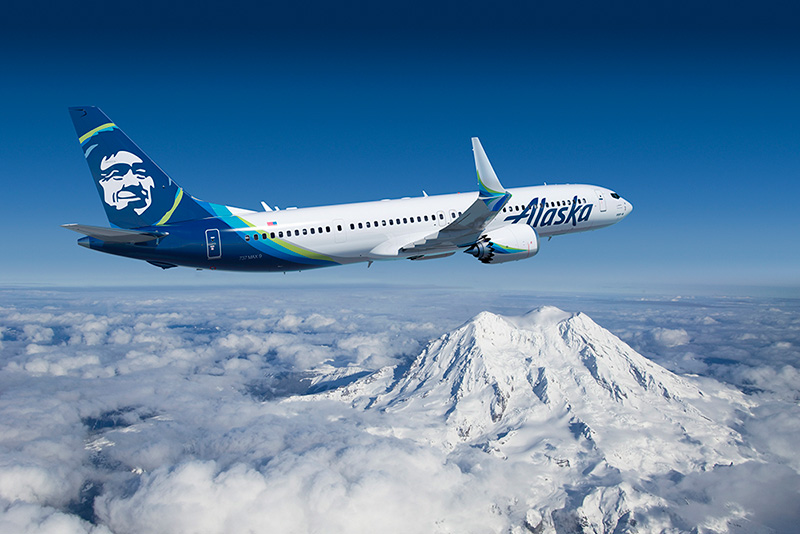 a plane flying over a mountain