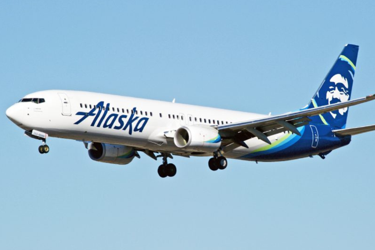 a white and blue airplane flying in the sky