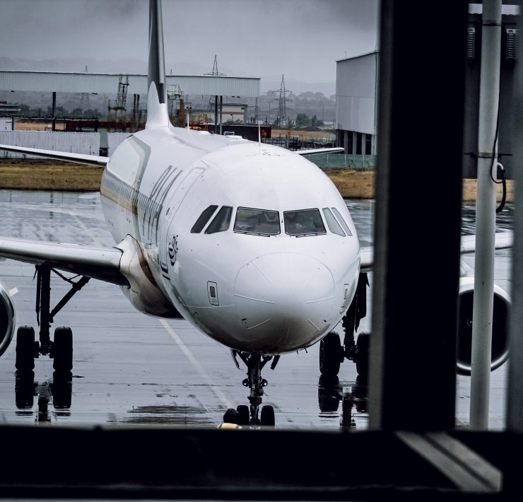 a white airplane on a wet runway